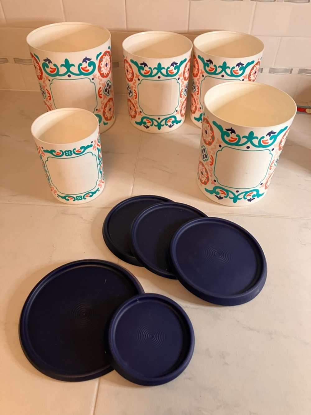 Tupperware Ceramic Look patterned Canister Set with Navy Blue Lids. 5 with lids.